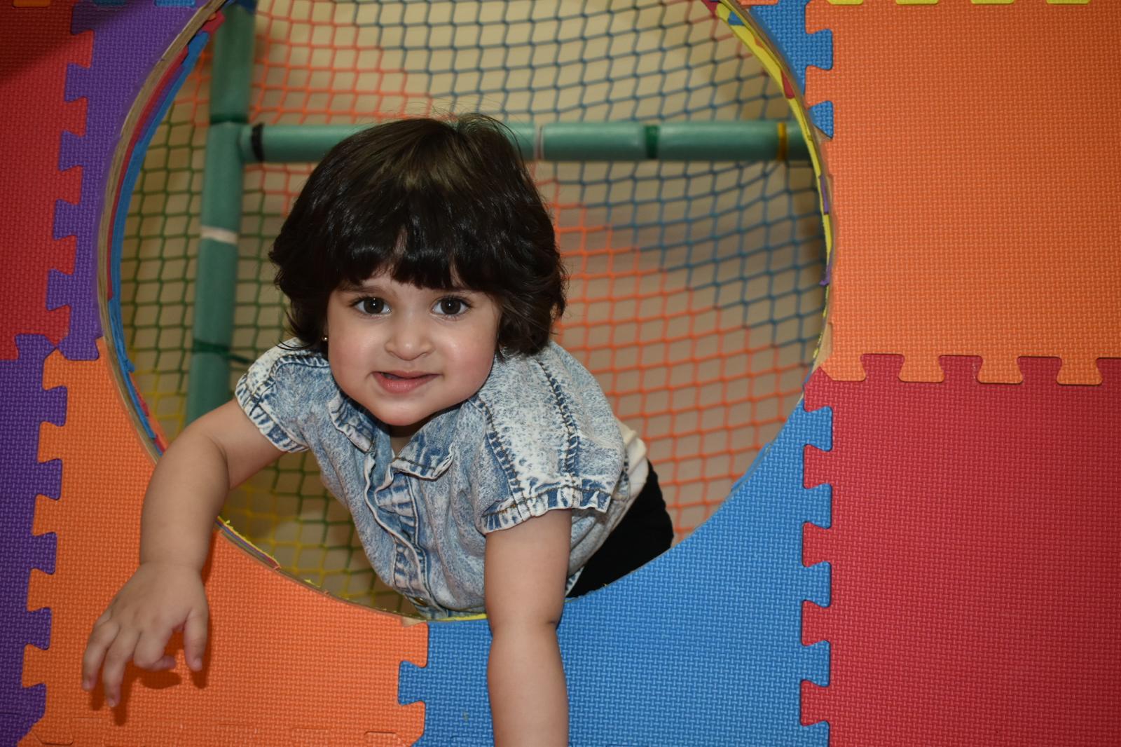 Young boy wearing a Kiddie Kingdom hard hat